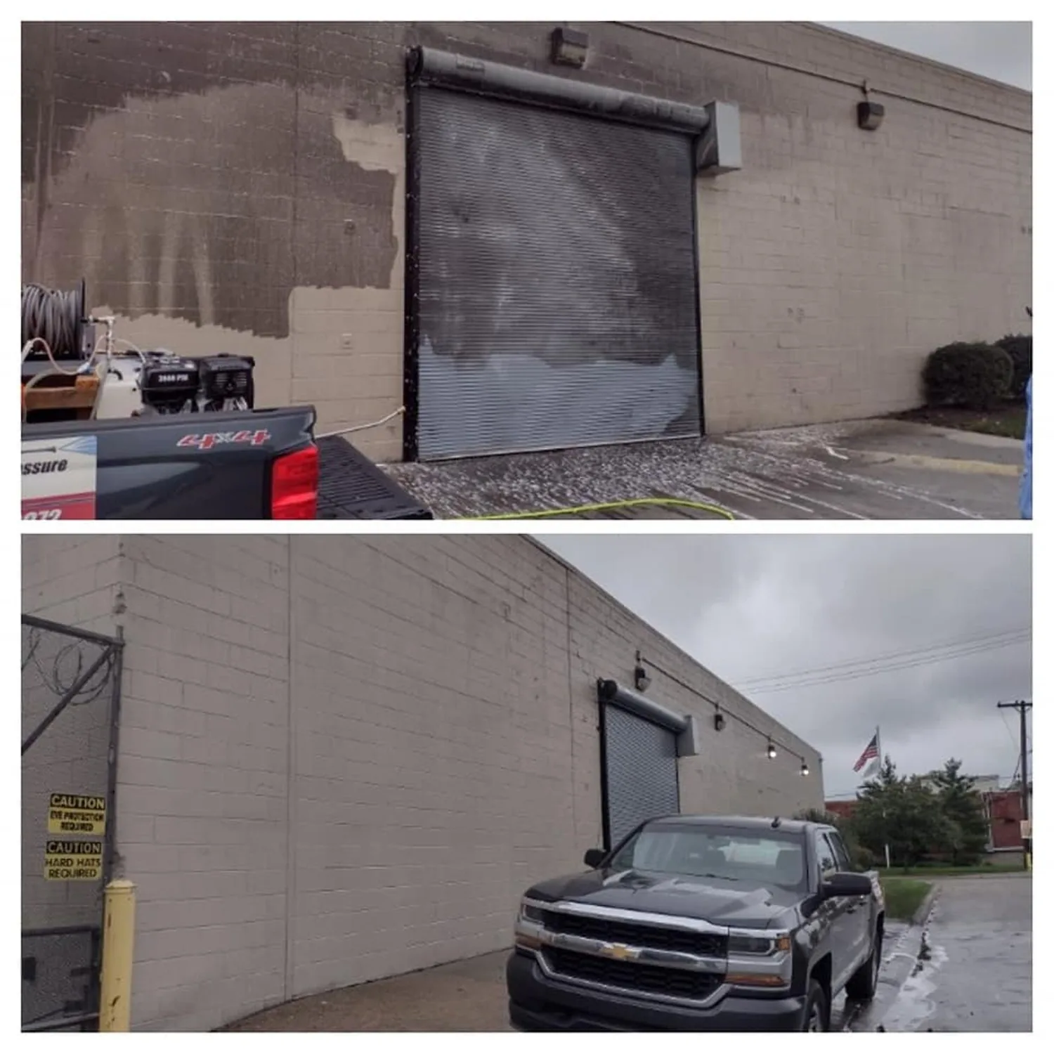 A painted concrete-block industrial elevation and its steel roll-up loading dock door, photographed mid-wash with a clean stripe running down the dirty wall.